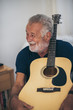 © chokniti - The old man and his guitar in the house