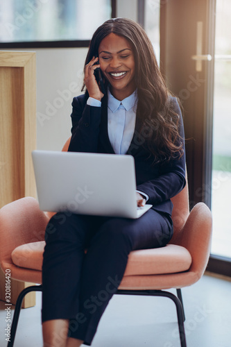 Smiling African America businesswoman working and talking on her
