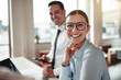 © Flamingo Images - Businesswoman smiling while working with a colleague in an offic