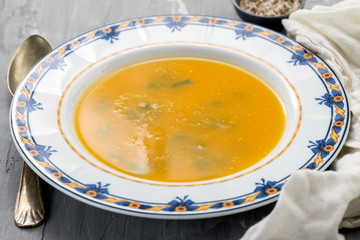 Poster - vegetable soup in beautiful dish on ceramic background