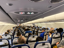 Cabin Of A Modern Airplane Filled With Passangers To Its Full Capacity During Flight, After Delayed Departure (shallow DOF)