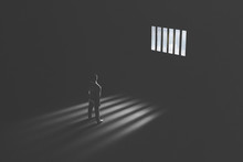 Man In Prison Observing Light Behind Bars