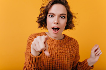 Wall Mural - Lovely white girl with casual makeup posing with excitement. Indoor close-up photo of attractive curly woman in bright knitted sweater.