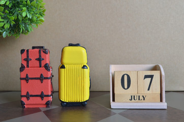 Appointment Date, July 7, Holiday, Travel cover with number cube and luggage.