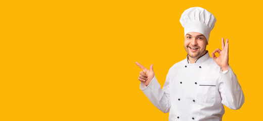 Chef Gesturing Okay Pointing Finger At Copy Space, Yellow Background