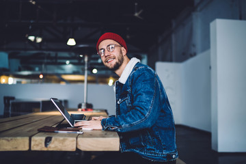 Smiling young man using laptop for work
