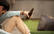 © mkitina4 - Addiction hungover drunk man hold bottle of beer in hand sit and inactive sleep.Unemployed young asian man suffering from financial problem hopeless feeling use alcohol stop pain.