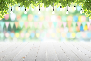 Wall Mural - Empty wooden table with party in garden background blurred.