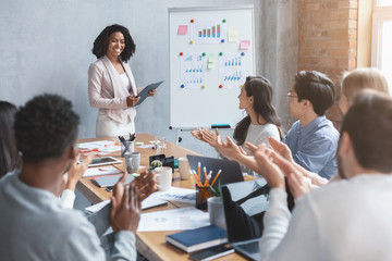 Canvas Print - International business team applausing to black lady speaker