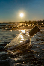 Bottle With A Message In The Sea At Sunset