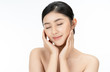 Beautiful young Asian woman with beauty skin healthy touching her own face softly in beauty pose and eyes closed. Facial treatment, cosmetology, spa, natural makeup beautiful concept.