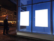 © Alex - advertising poster in the window on the display window glowing. on a blue background in the late evening