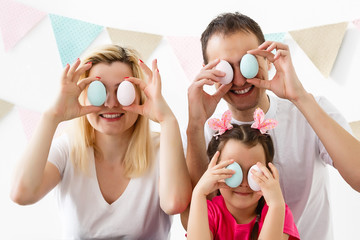 Wall Mural - happy family with easter eggs. Happy family preparing for Easter.