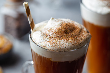 Iced coffee in a tall glasses with cream poured over