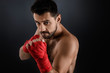 © Rychko Yevhen - Muscular boxing man ready to fight on black background
