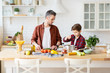 © deniskomarov - Father and son cooking homemade food together