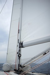 Wall Mural - Detail of a moving sailboat with main mast and rigging