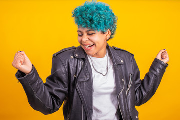 afro american girl with blue curly hair isolated on yellow background