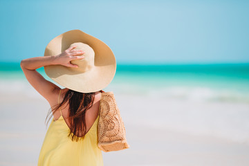 Poster - Young beautiful woman having fun on tropical seashore. Happy girl background the blue sky and turquoise water in the sea on caribbean island