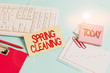 Handwriting text Spring Cleaning. Conceptual photo thorough cleaning of a house or room during spring Paper blue desk computer keyboard office study notebook chart numbers memo