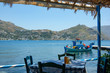 A greek taverna by the seaside on the quiet, traffic free island of Telendos.  On the horizon is the neighbousing, larger, island of Kalymnos.