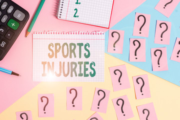 Text sign showing Sports Injuries. Business photo showcasing kinds of injury that occur during sports or exercise Mathematics stuff and writing equipment above pastel colours background