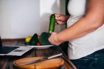 Wall Mural - Overweight woman recording video cooking healthy food at home kitchen. Cooking recipe online culinary blog, weight loss support