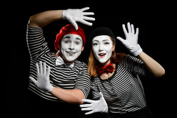 Wall Mural - Smiling mimes in striped shirts. Man and woman, dressed as actors