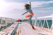 © Alena Ozerova - Hip hop dancer in fashion sportswear jumping and dancing in the street