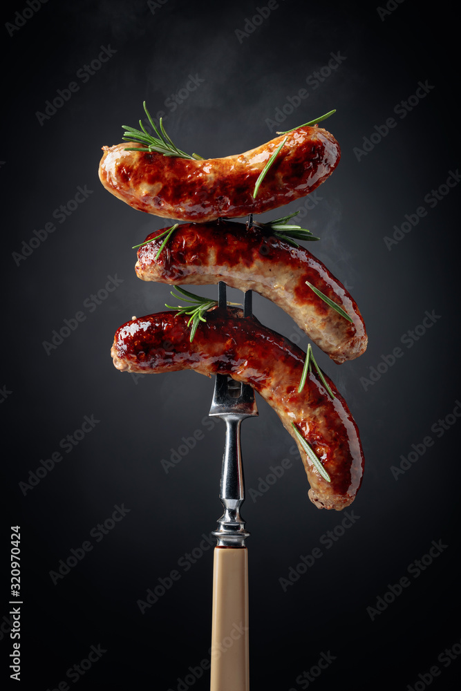 Grilled Bavarian sausages with rosemary. - obrazy, fototapety, plakaty 