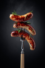 Wall Mural - Grilled Bavarian sausages with rosemary.