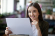 © zinkevych - Lovely joyful girl with a document in hand.