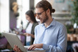 © zinkevych - Successful happy man holding a laptop in his hands.