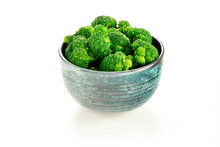A Bowl Of Cooked Broccoli On A White Background
