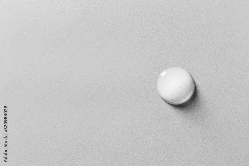 Drop of water on grey background