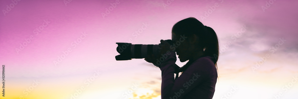 Professional photographer woman silhouette taking night photo during photography safari travel tour for tourists. Girl holding slr camera with telelens panoramic banner. - obrazy, fototapety, plakaty 