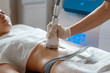 © Ilnur - Hardware cosmetology. Body care. Spa treatment. Ultrasound cavitation body contouring treatment. Woman getting anti-cellulite and anti-fat therapy in beauty salon.