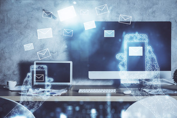 Desktop computer background in office and flying envelops hologram drawing. Multi exposure. Electronic mail concept.