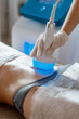 © Ilnur - Hardware cosmetology. Body care. Spa treatment. Ultrasound cavitation body contouring treatment. Woman getting anti-cellulite and anti-fat therapy in beauty salon.