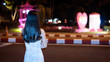 © ArLawKa - A young woman stood at the side of the street at night and looked at the heart shape.