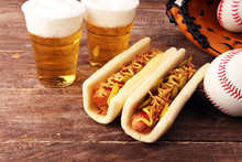 Grilled Hot Dogs With Mustard And Ketchup On The Table With Draft Beer. Baseball Party Food With Balls For The Playoffs
