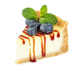 Wall Mural - Cheesecake with fresh blueberries, caramel syrup and mint leaves isolated on white