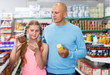 © JackF - smiling father doing shopping with preteen girl in supermarket