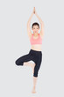 © NT_studio - Beautiful happy young asian woman doing yoga exercise sport for leisure and relax isolated on white background, asia girl standing workout with stretch muscle arm for healthy and wellbeing.