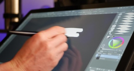 Wall Mural - a digital artist selecting a color hue and painting with a drawing graphic tablet and pen in an art 
