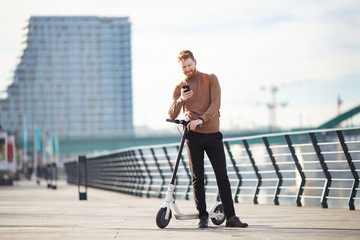 young businessman on e scooter in the city