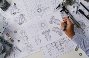Fototapete - Engineer technician designing drawings mechanical parts engineering Engine.manufacturing factory Industry Industrial work project blueprints measuring bearings caliper tools