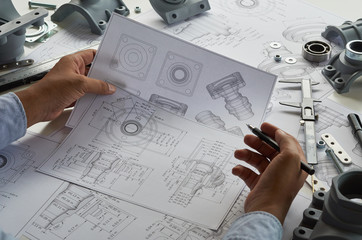 Fototapete - Engineer technician designing drawings mechanical parts engineering Engine.manufacturing factory Industry Industrial work project blueprints measuring bearings caliper tools