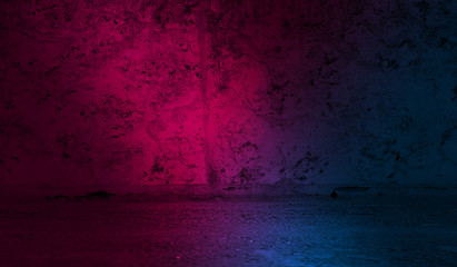 Dark abstract background. Background of an old concrete wall illuminated by a blue and pink neon spotlight