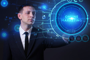 Business, Technology, Internet and network concept. Young businessman working on a virtual screen of the future and sees the inscription: Online marketing